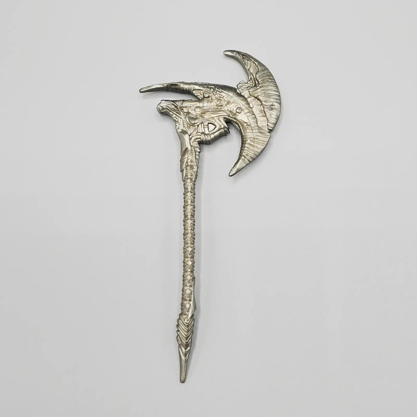 Decorative silver axe on a light gray background