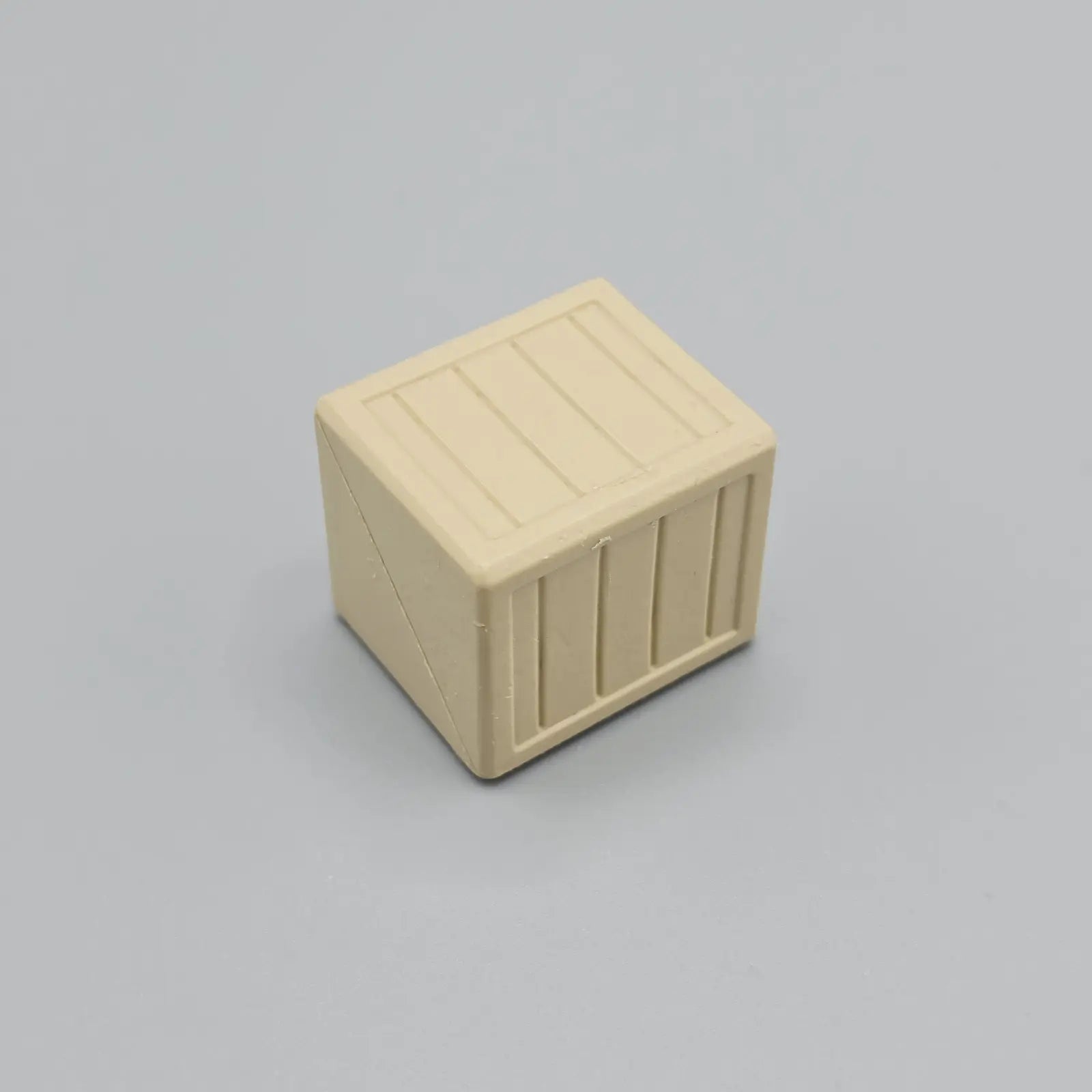 Beige rectangular block with horizontal slats on a gray background