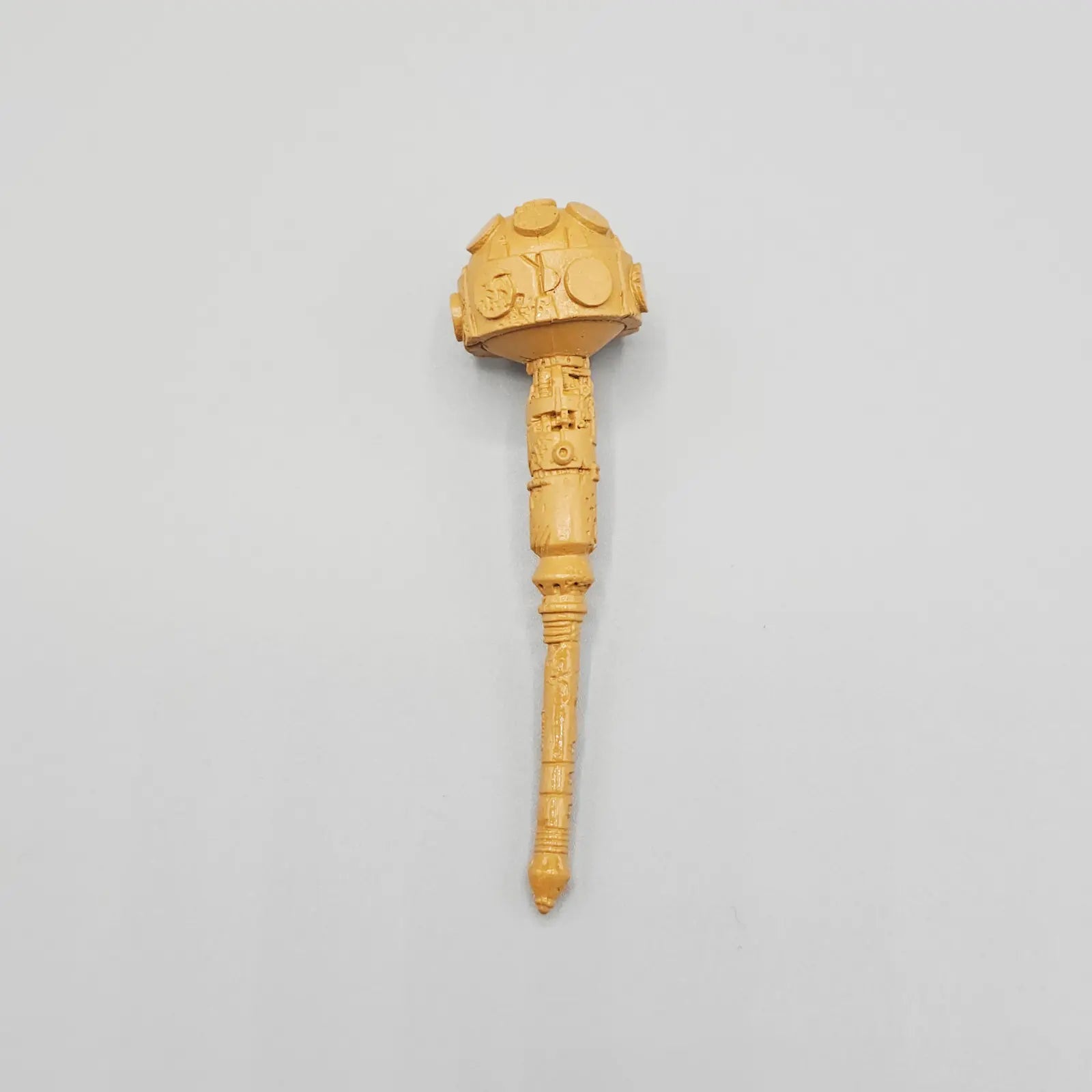 Orange action figure mace on grey background