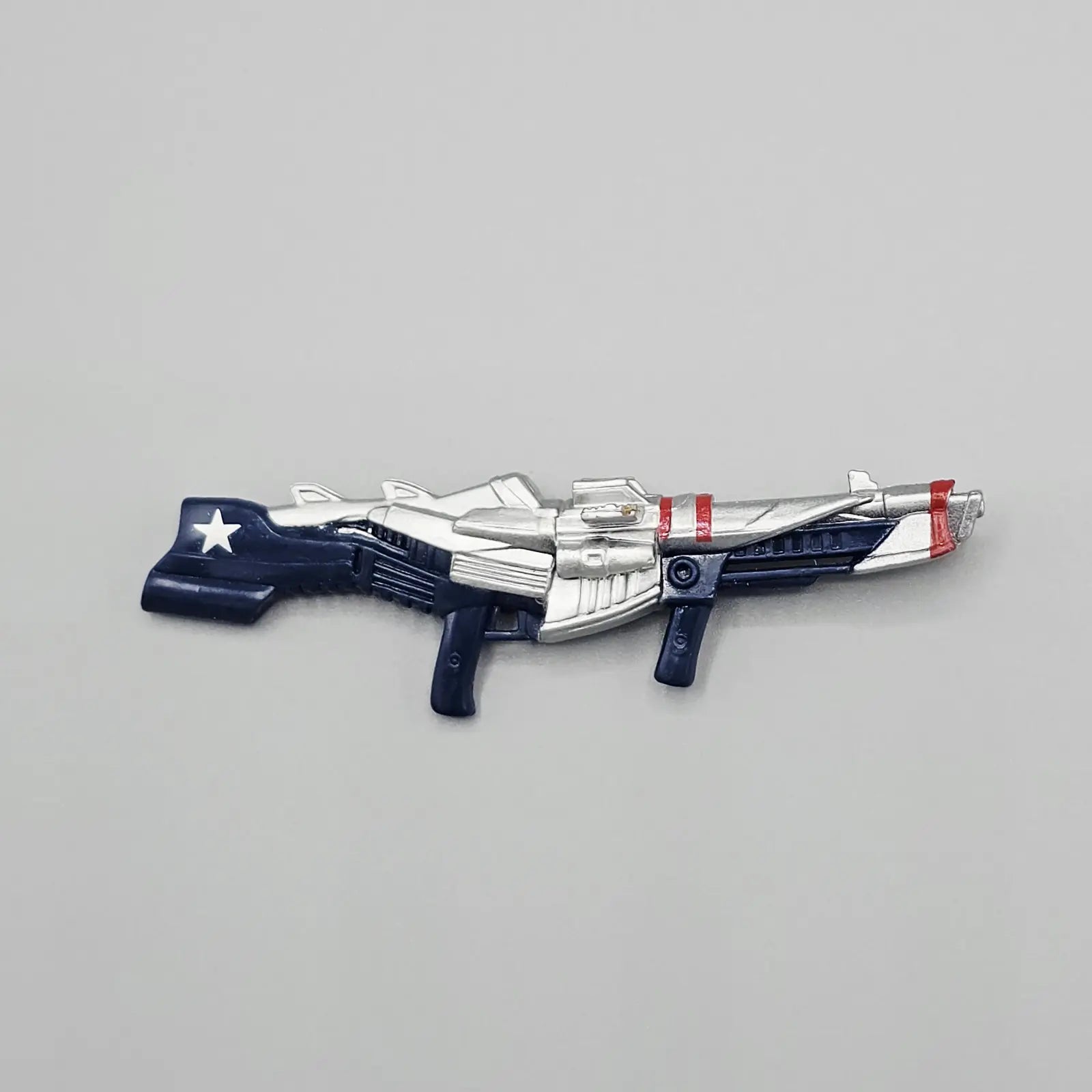 Toy gun with American flag design on a gray background