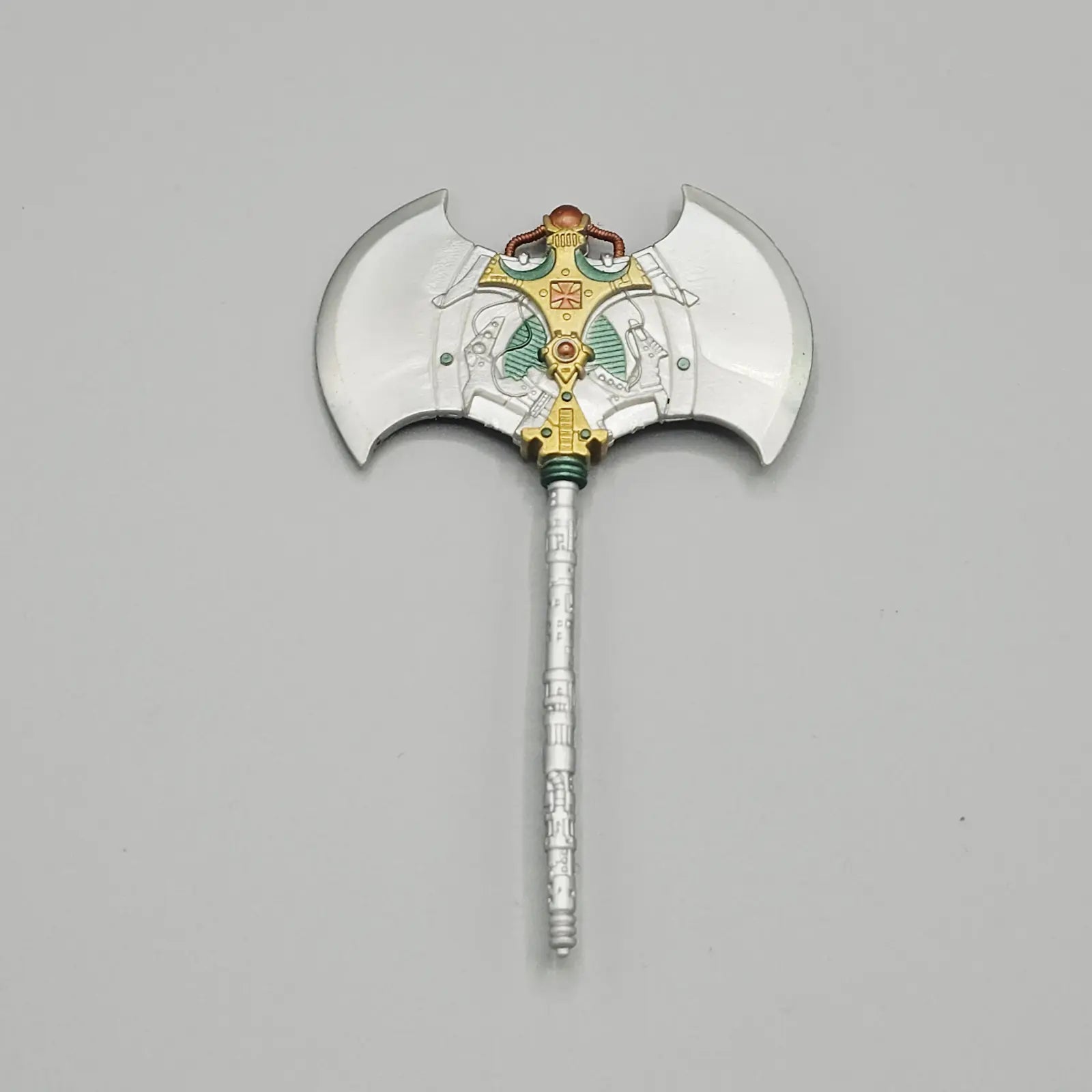 Decorative axe with intricate design on a gray background