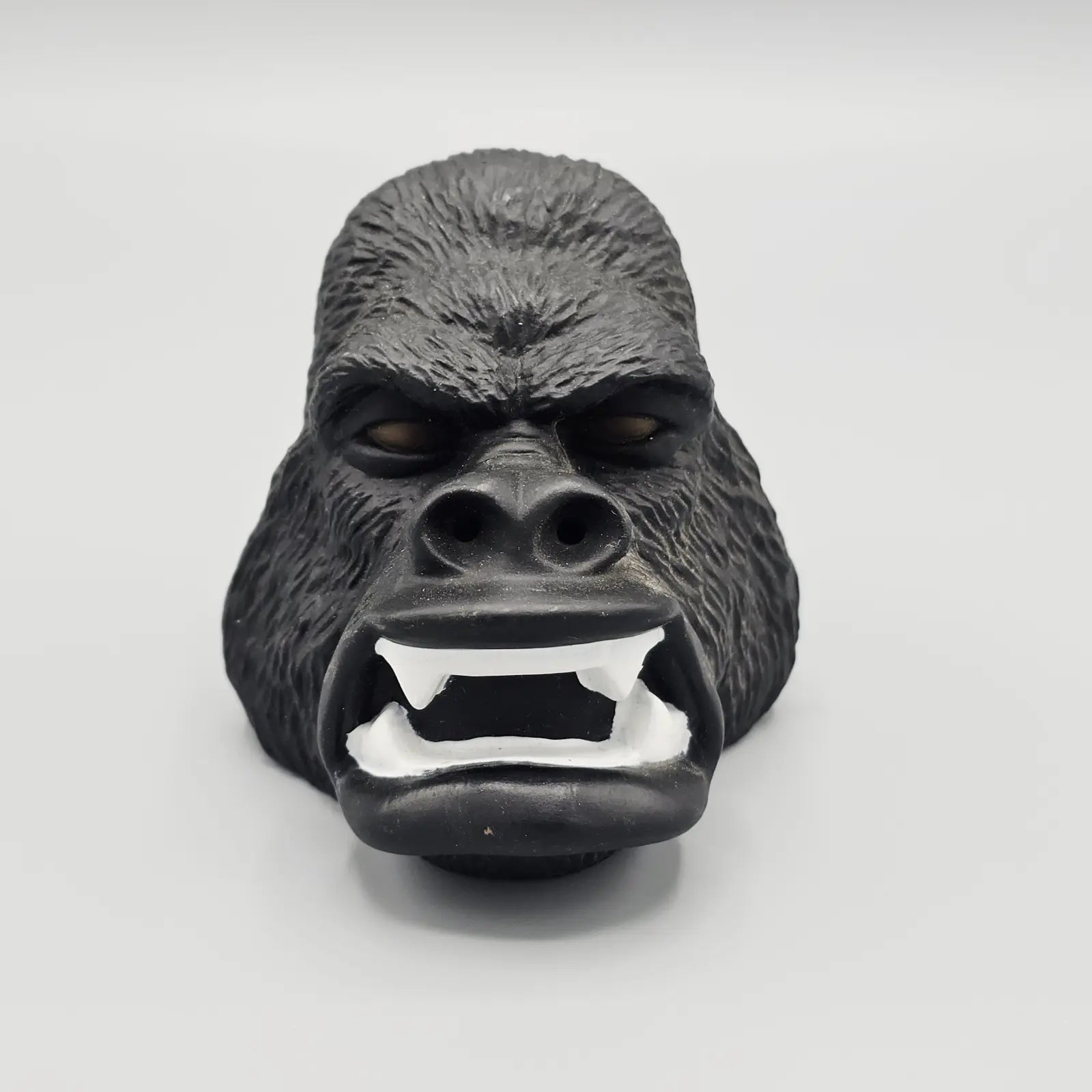 Gorilla mask with a fierce expression on a white background