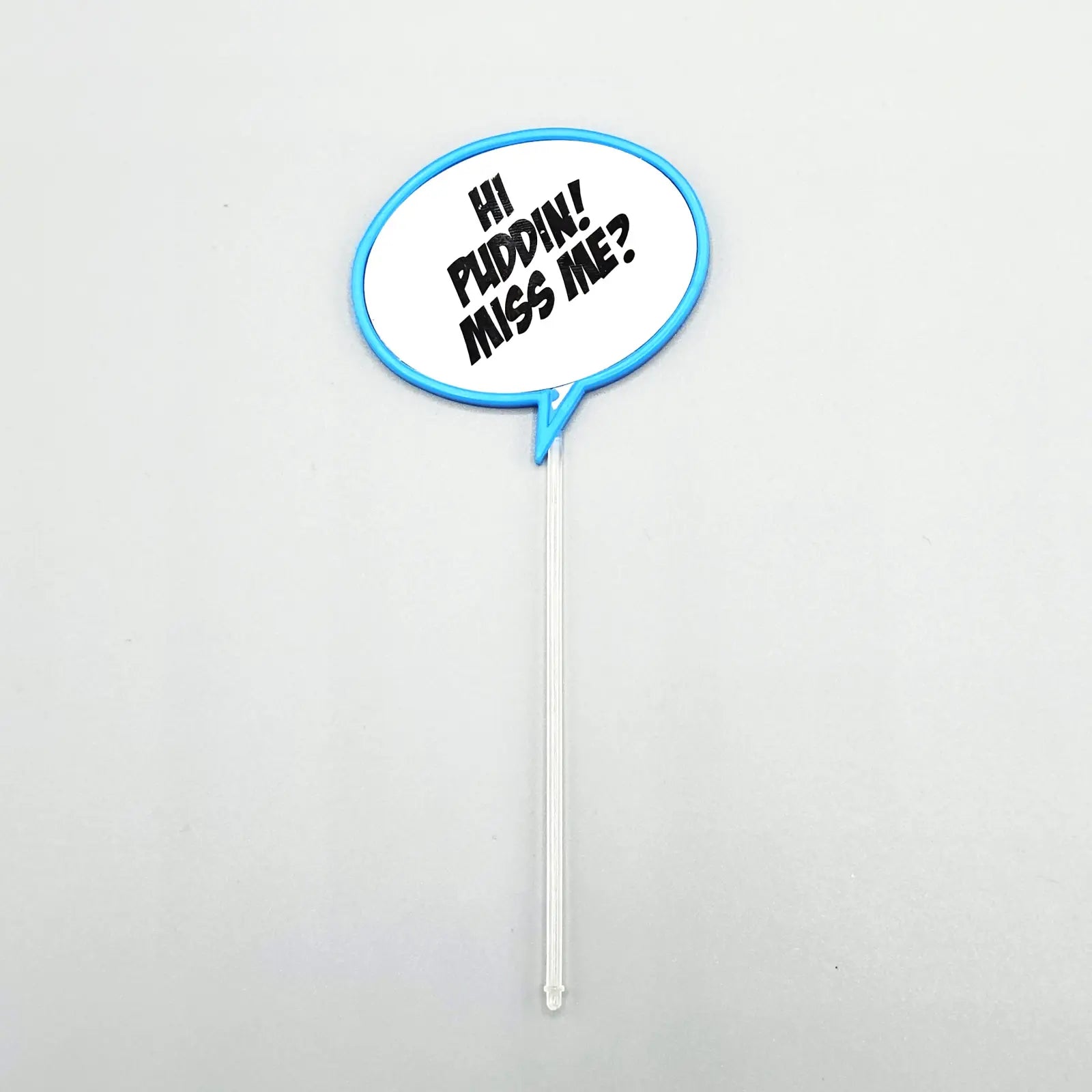 Decorative pick with speech bubble saying 'Hi Puddin' Miss Me?' on a white background