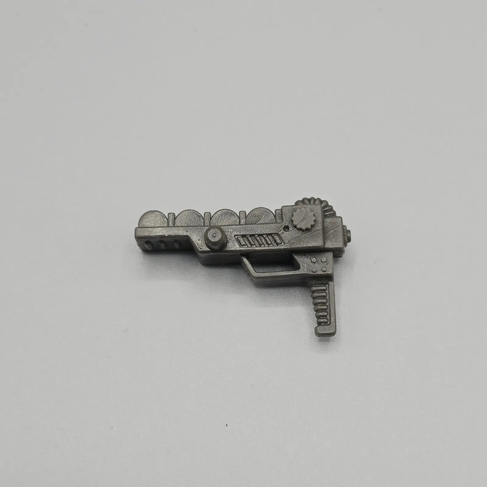 Action figure gun on a grey background