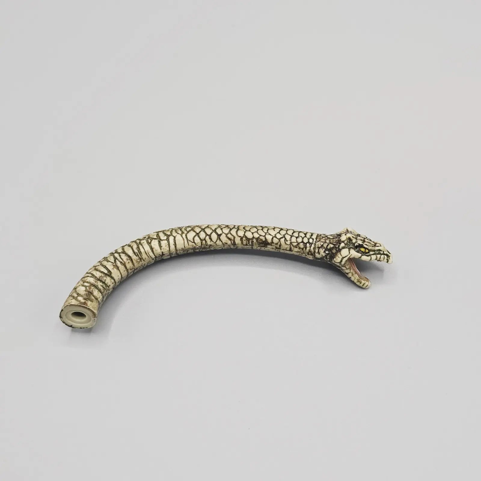 Action figure snake head part on grey background