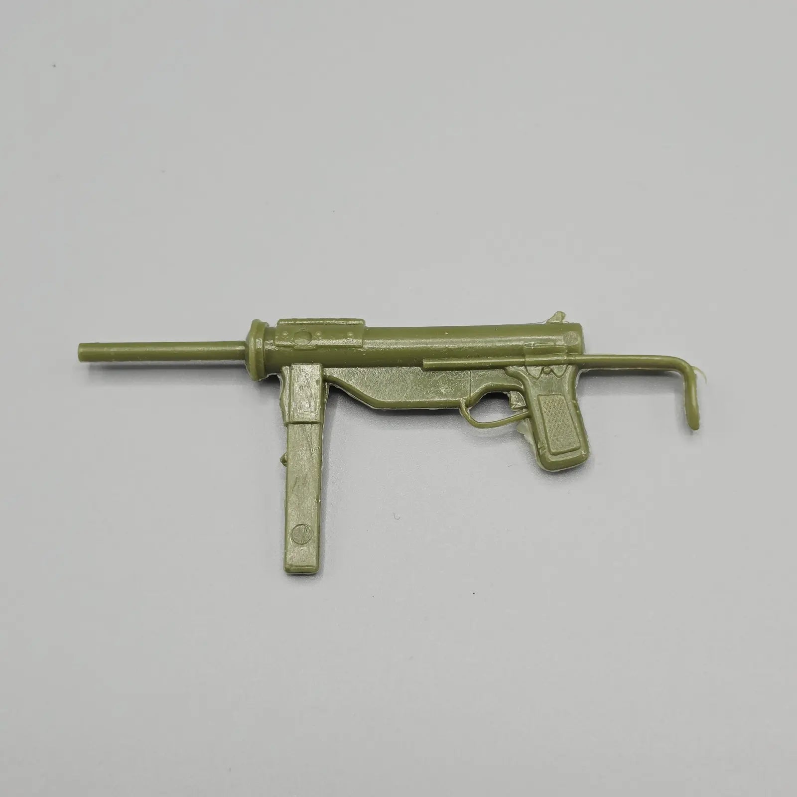 Toy gun on a gray background
