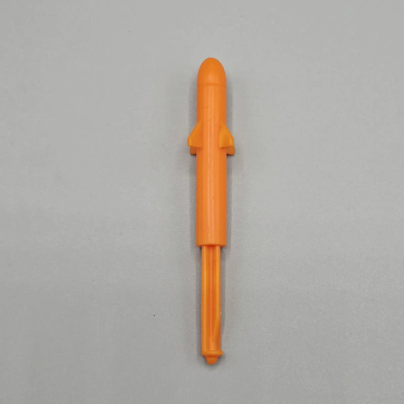 Orange board game missile on grey background