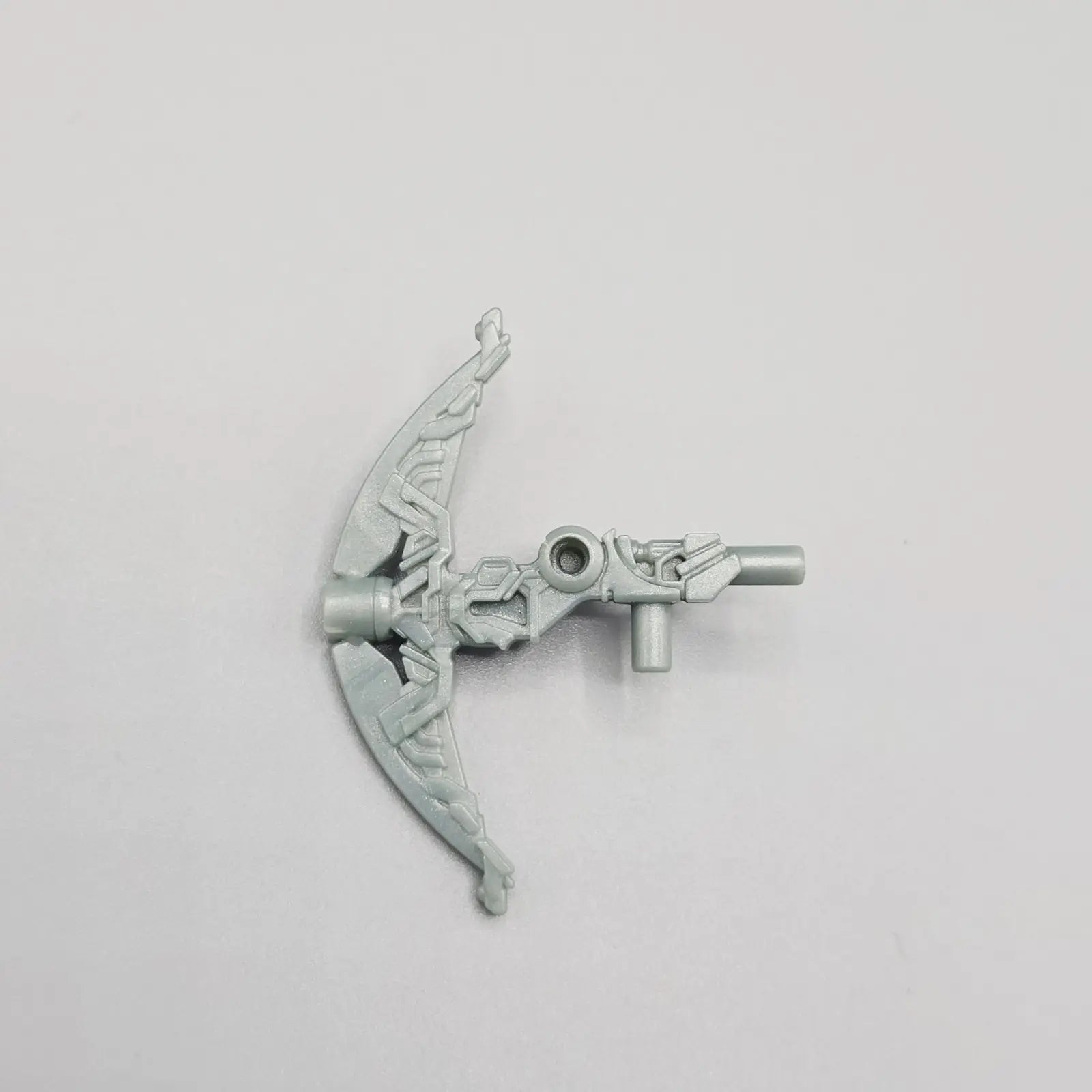 Metallic bow and arrow accessory on a gray background