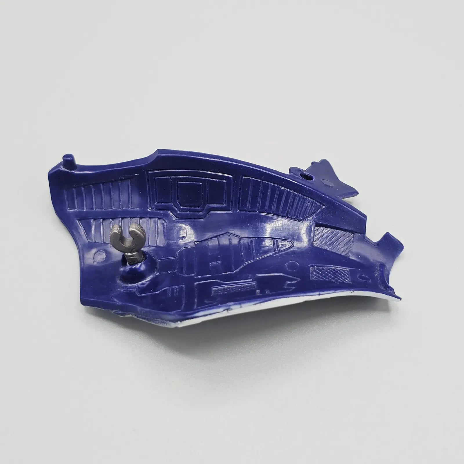 Blue action figure armor piece on grey background