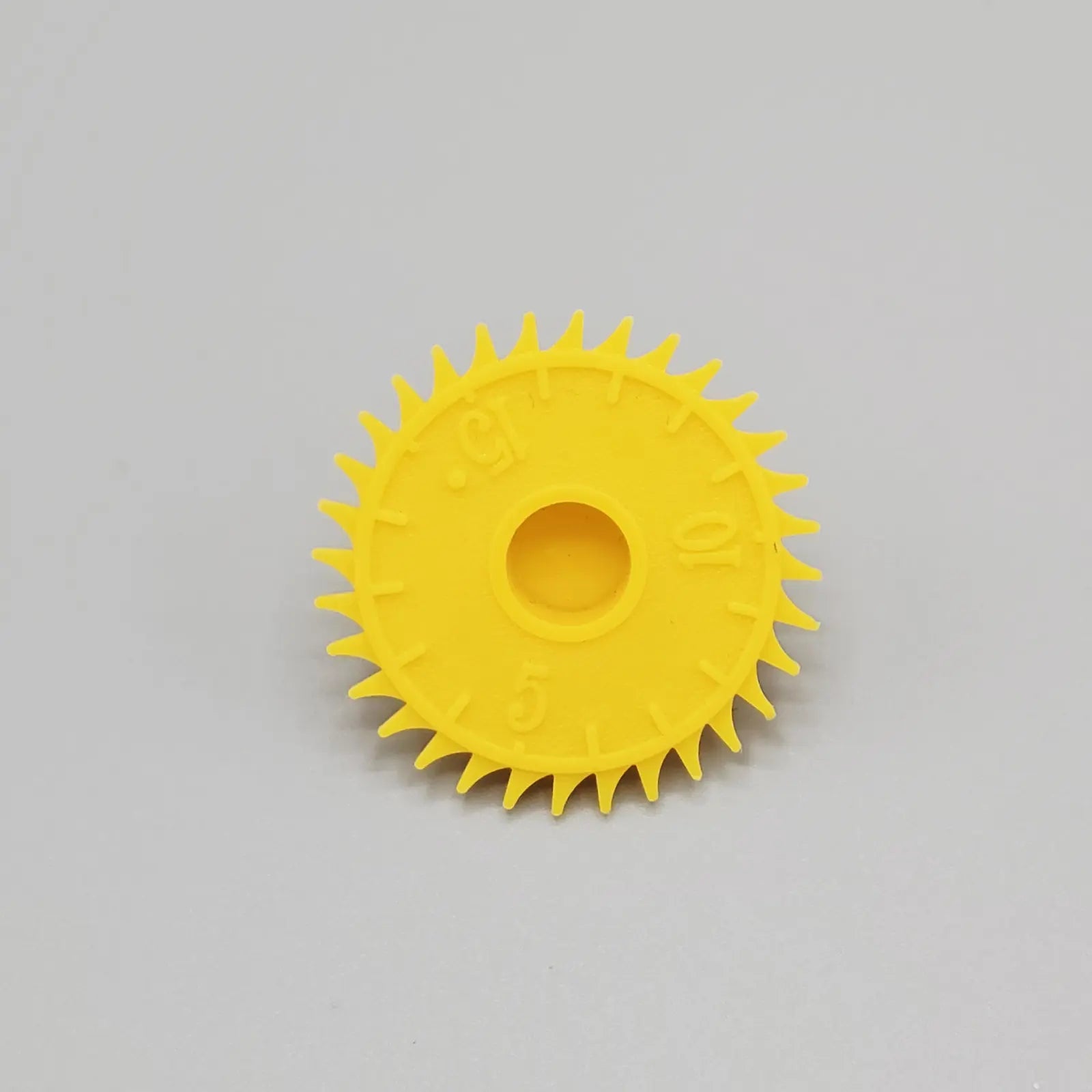 Yellow gear on a gray background